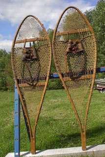 lot of snowshoes toboggans skis paddles and oars listed with a wide 