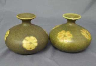   art pottery vase greenish brown with cream flowers around the body one