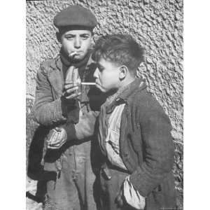 Two Homeless Boys Lighting Up American Cigarettes with British Matches 